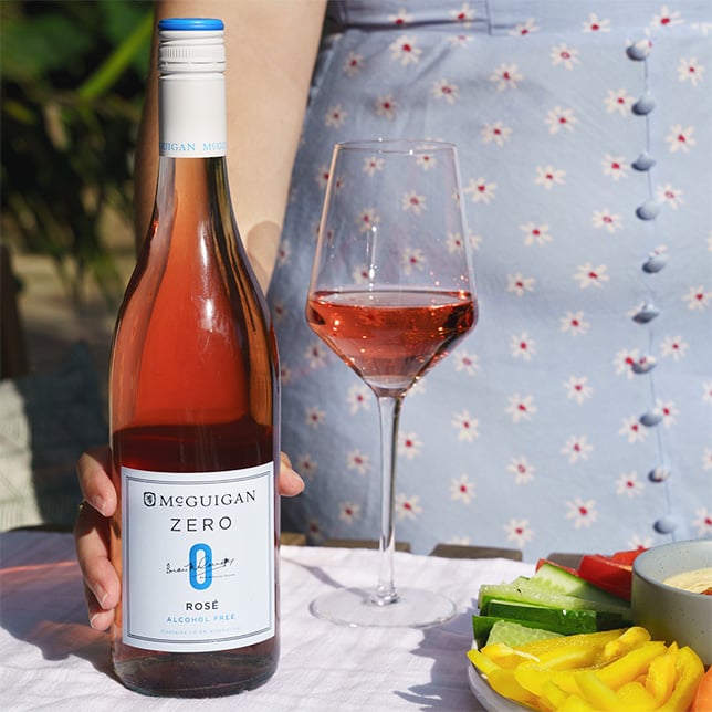 Girl holding a glass of McGuigan Zero rose with vegetables